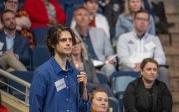 A student participate asks a question to the presenter.